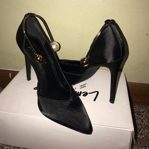 Black pumps with gold ankle strap
